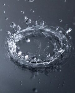 Close-up shot of a water splash in motion, showcasing dynamic movement and intricate details.